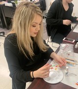 Gina Horn KACC Alumnus, now salon owner, teaching nail design techniques to students.